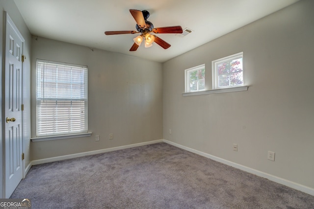 spare room featuring light carpet and ceiling fan