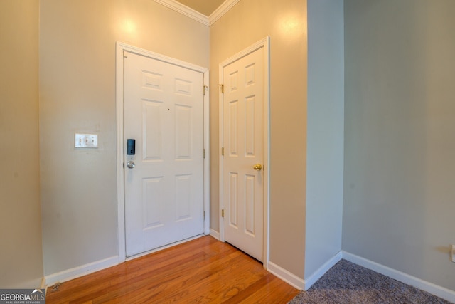 entryway featuring crown molding and hardwood / wood-style floors