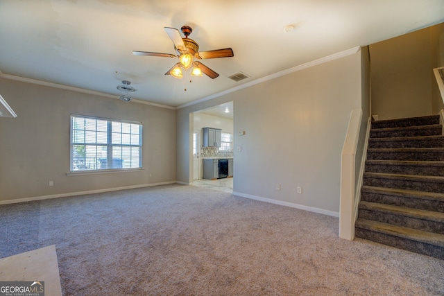 unfurnished living room with crown molding, ceiling fan, and light colored carpet