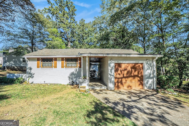 ranch-style home with a front yard and a garage