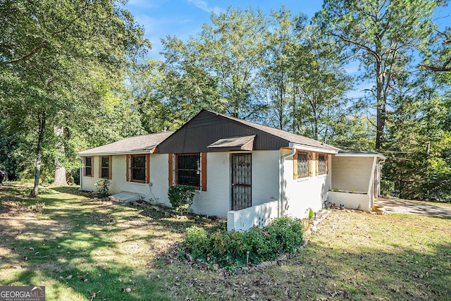 view of side of property with a yard