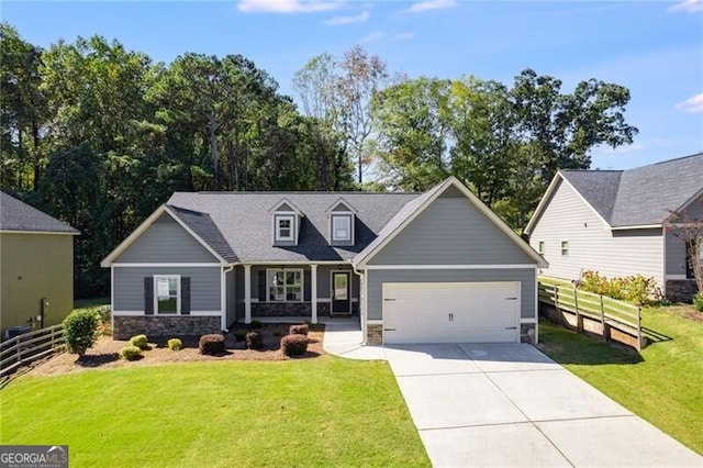 view of front facade featuring covered porch, a front yard, and a garage