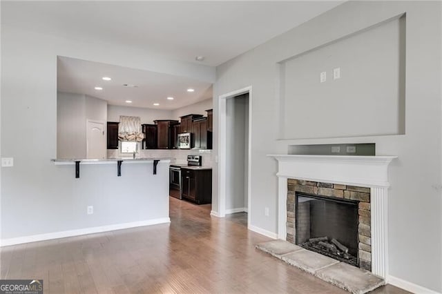 unfurnished living room featuring a fireplace and light hardwood / wood-style floors