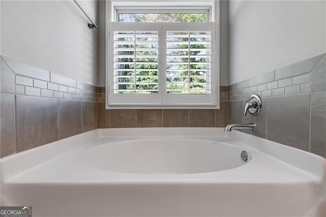 bathroom with a tub to relax in