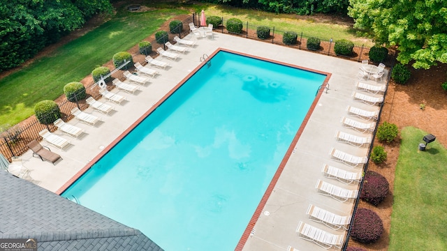 view of pool featuring a patio and a yard