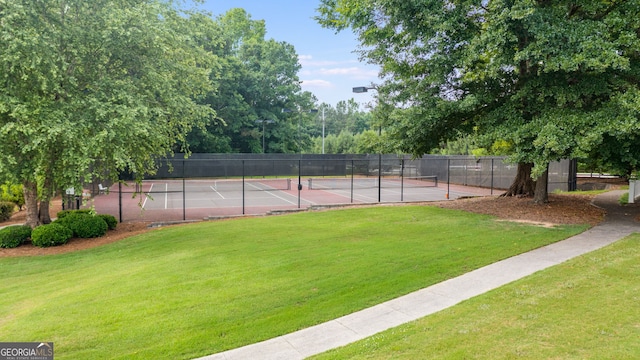 view of tennis court with a lawn