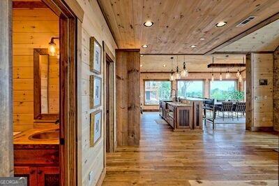 corridor featuring wood-type flooring, wood ceiling, and wood walls