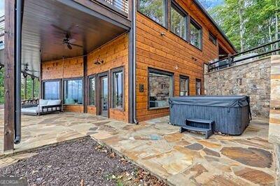 view of patio / terrace featuring ceiling fan and a hot tub