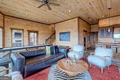 living room with wood walls and wood ceiling