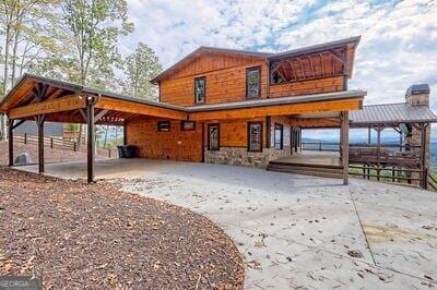 rear view of house featuring a carport