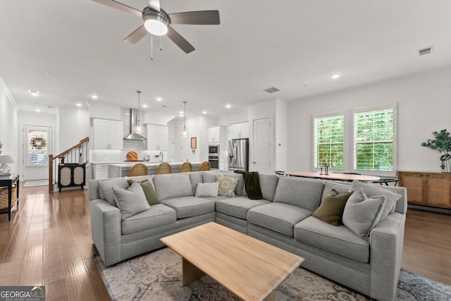 living room featuring ceiling fan and wood-type flooring