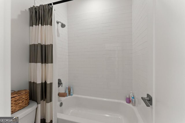 bathroom with shower / tub combo and toilet