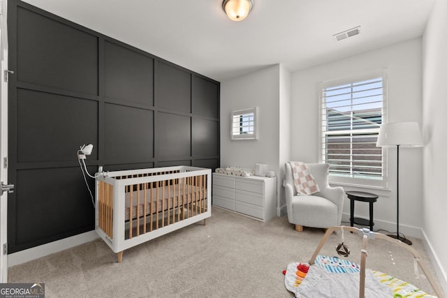 carpeted bedroom with a nursery area