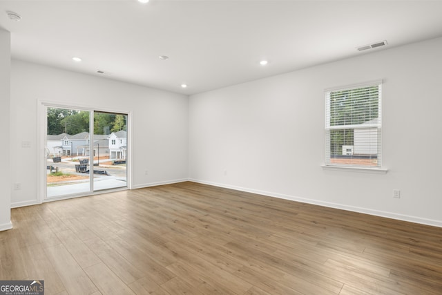 spare room featuring light hardwood / wood-style floors