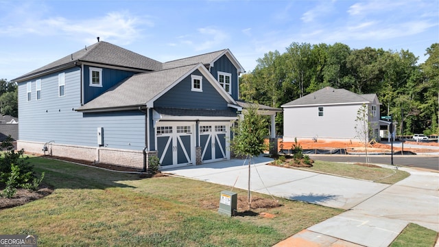 view of front of property with a garage and a front lawn