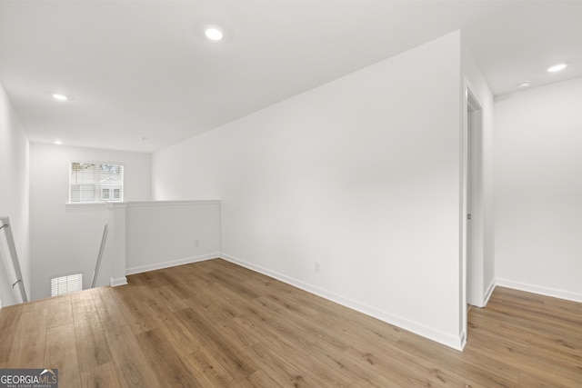 spare room featuring wood-type flooring