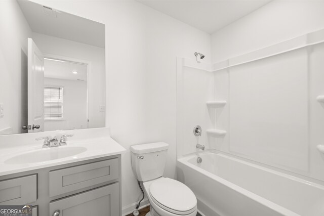 full bathroom featuring vanity, bathing tub / shower combination, and toilet