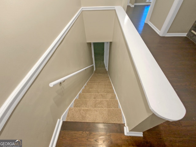 stairs featuring hardwood / wood-style floors