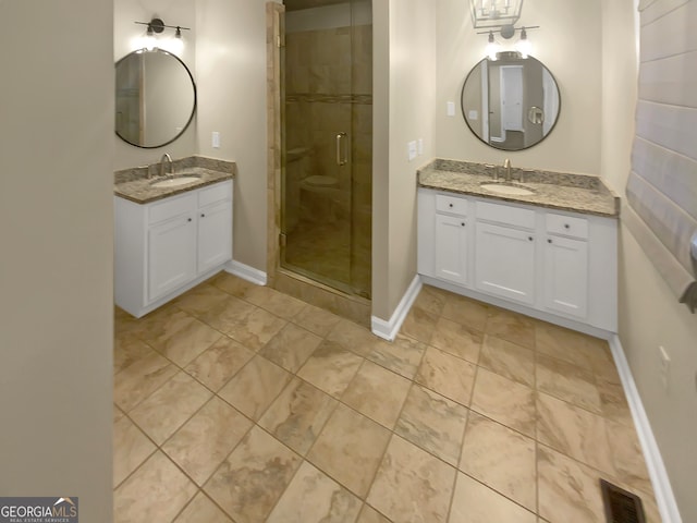 bathroom with a shower with door and vanity