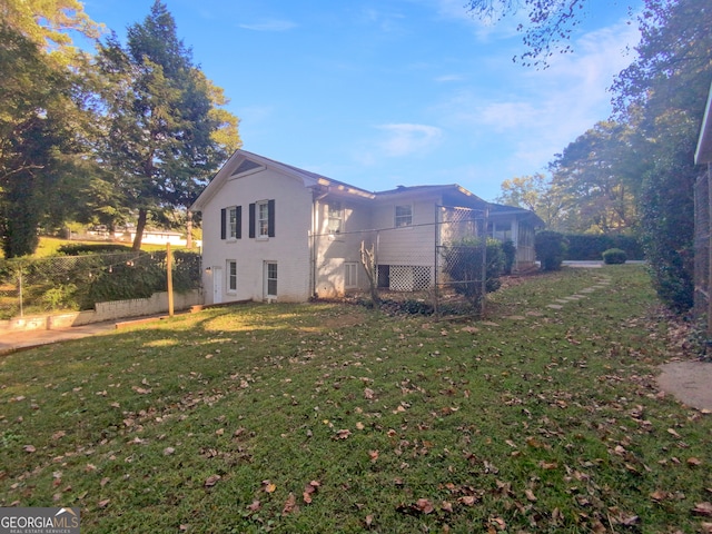 view of side of home featuring a yard