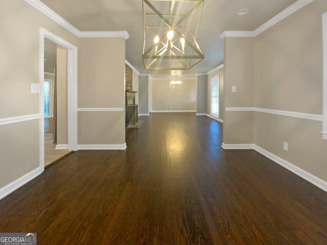 unfurnished dining area with crown molding, an inviting chandelier, and dark hardwood / wood-style floors