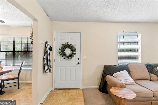 foyer featuring a textured ceiling and plenty of natural light