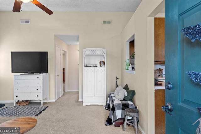 interior space with a textured ceiling and ceiling fan