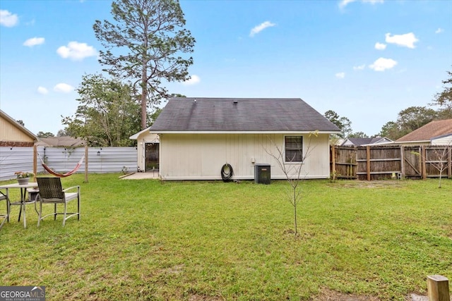 back of house with a yard, a patio area, and central AC