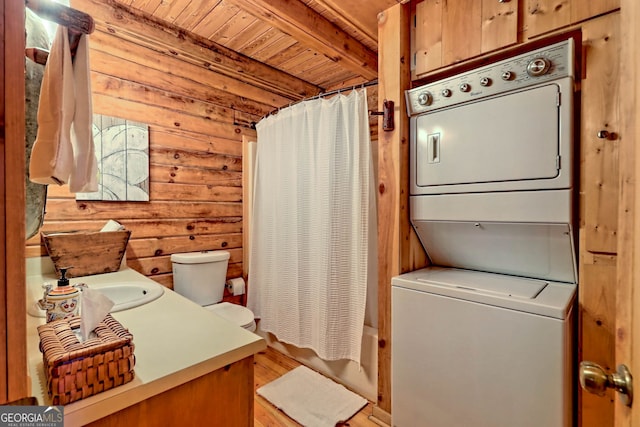 laundry area featuring sink, wooden walls, light hardwood / wood-style flooring, stacked washer / dryer, and wooden ceiling