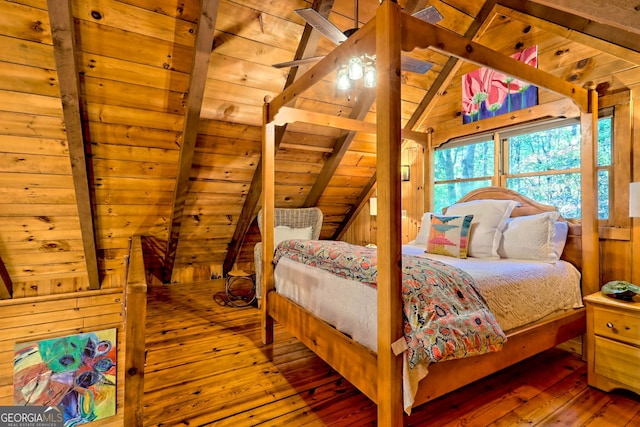 bedroom with hardwood / wood-style flooring, wooden walls, lofted ceiling with beams, and wooden ceiling