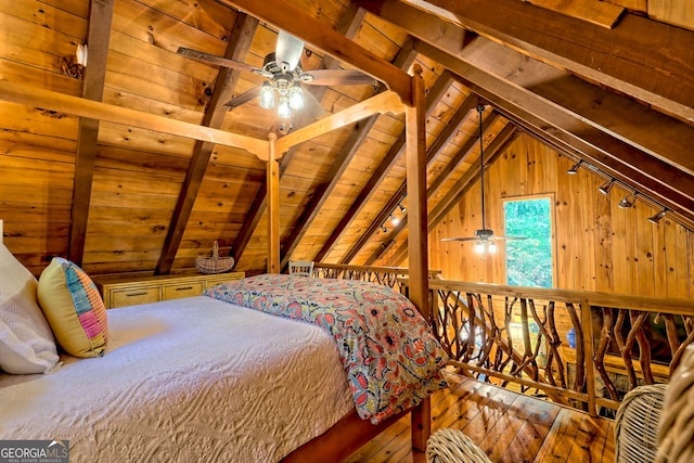 bedroom with wood walls, ceiling fan, hardwood / wood-style floors, wood ceiling, and vaulted ceiling with beams