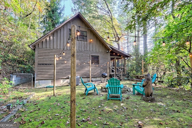 exterior space featuring a fire pit and a lawn