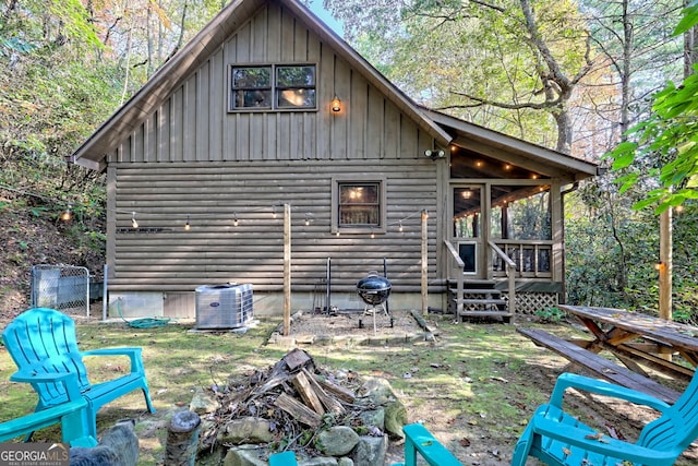 back of property with a sunroom, central AC, and a wooden deck