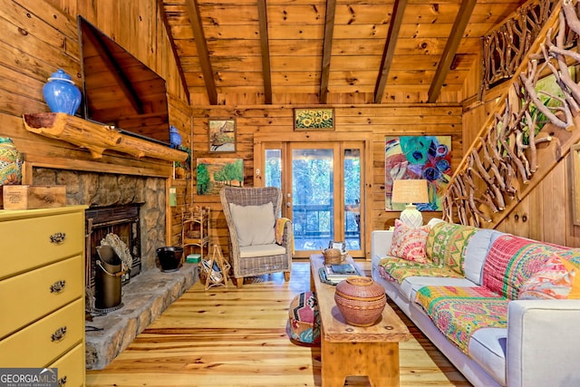 living room with a fireplace, wood walls, wood ceiling, and light hardwood / wood-style floors