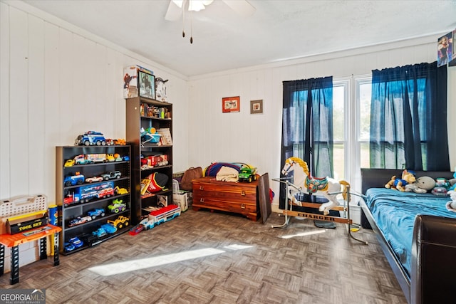 bedroom featuring ceiling fan, wood walls, and parquet floors