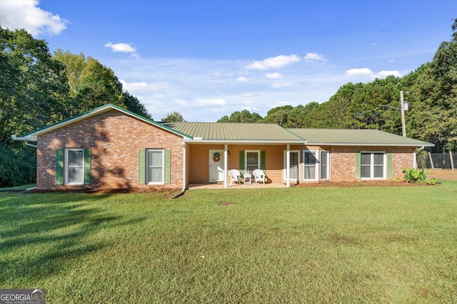 ranch-style home with a front yard and a patio area