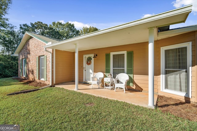 back of property featuring a yard and a patio