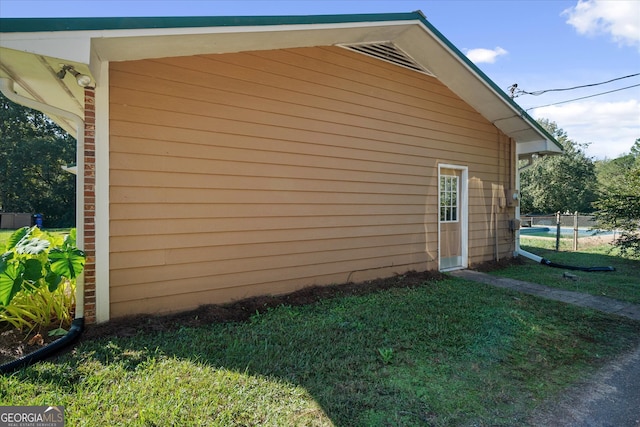 view of side of property with a lawn