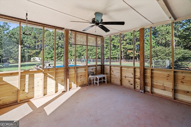 unfurnished sunroom featuring ceiling fan