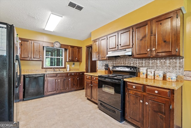 kitchen with black appliances, backsplash, sink, and a textured ceiling