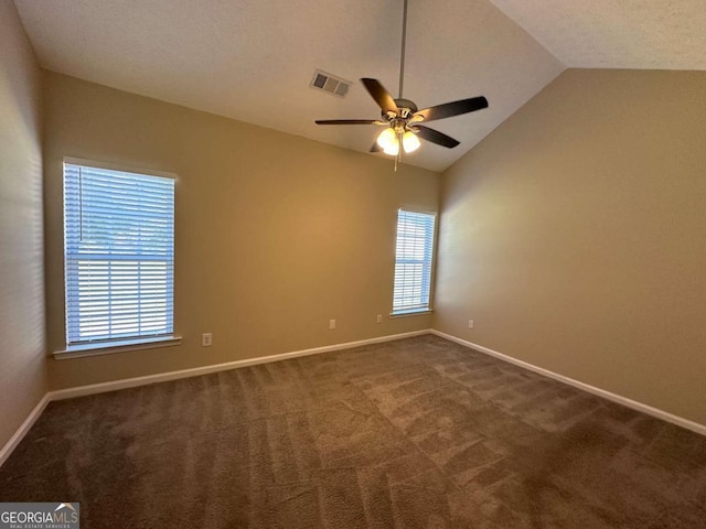 carpeted spare room featuring lofted ceiling and ceiling fan