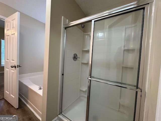 bathroom with wood-type flooring and independent shower and bath