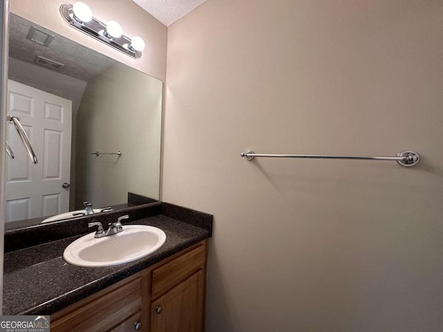 bathroom featuring vanity and a textured ceiling