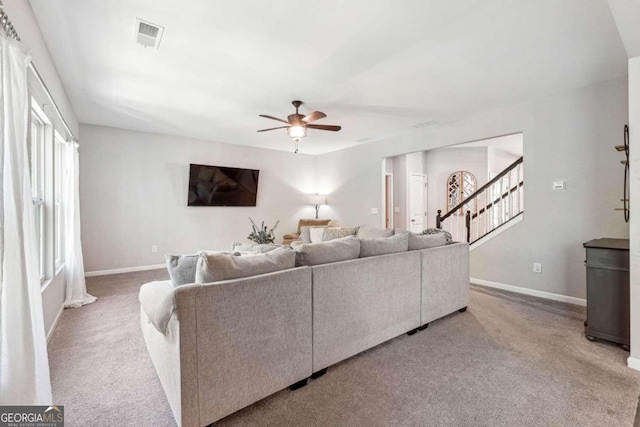 carpeted living room featuring ceiling fan