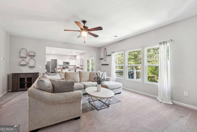 living room with light carpet and ceiling fan