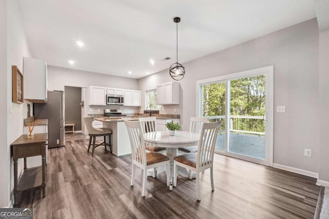 dining room with dark hardwood / wood-style flooring