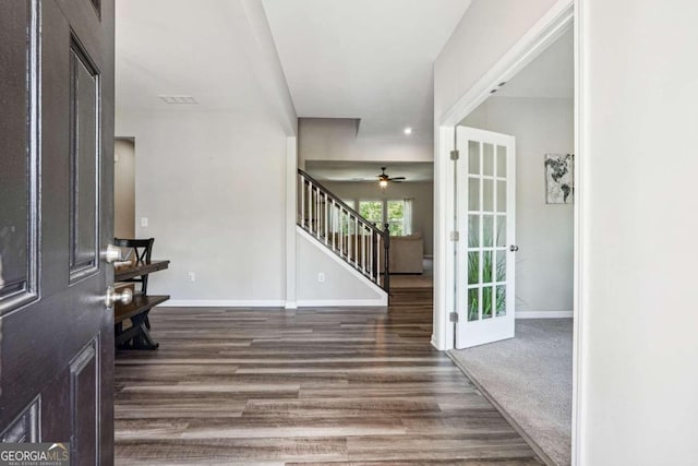 entryway with ceiling fan and dark wood-type flooring