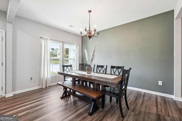 dining space featuring a chandelier and dark hardwood / wood-style flooring