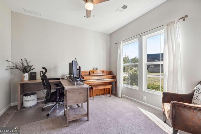 carpeted office featuring ceiling fan