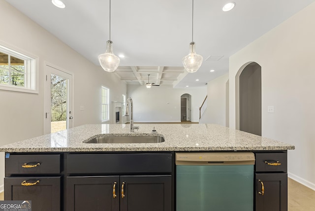 kitchen featuring an island with sink, light stone countertops, sink, dishwasher, and coffered ceiling